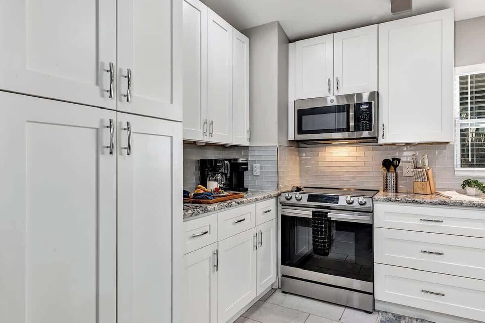 Spacious and elegant full kitchen! Large french door refrigerator, pots, pans, silverware, cooking utensils, blender, air fryer, insta pot, drip coffee machine, Keurig coffee machine, 3 comfortable bar stools around spacious island.