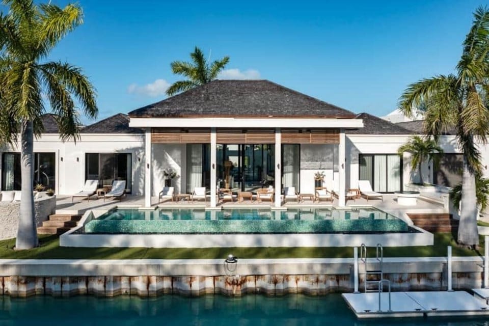 Casa Caoba from the water — pool, dock, and open skies