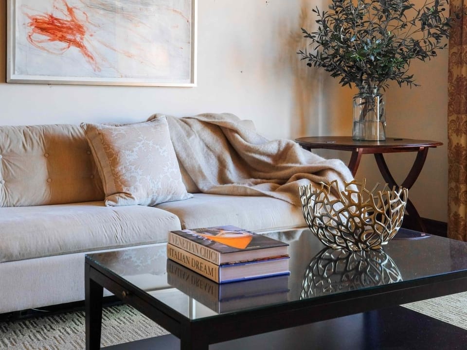 Settle in with a cozy sofa, artful accents, and warmth.