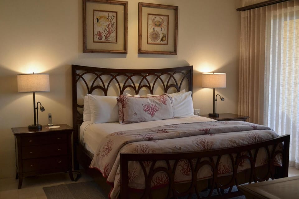 Unwind in a serene bedroom with soft lamps and linens.