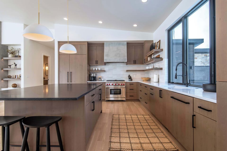 Gourmet kitchen from another perspective — ample counter space, high-end appliances, and Teton views that make even meal prep feel like an experience.