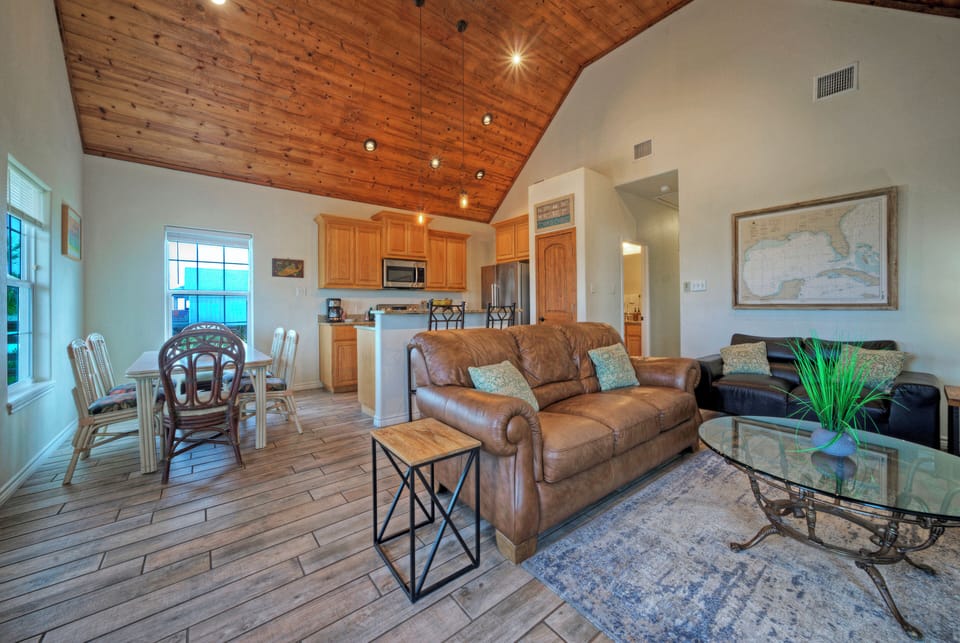 Cozy coastal living under soaring wood ceilings—open lounge and a fully equipped kitchen.