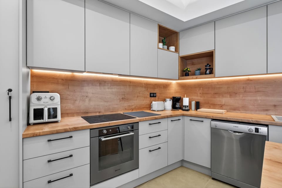 Modern kitchen with island seating and all essentials for home cooking.