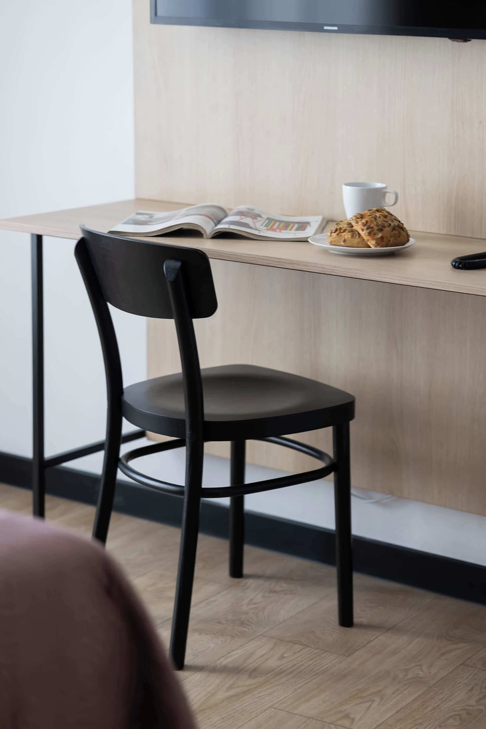 A close-up of a desk with a chair, perfect for remote work or studying.