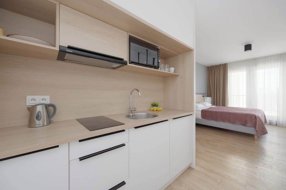 Practical kitchenette with countertop space and essential appliances for everyday cooking.