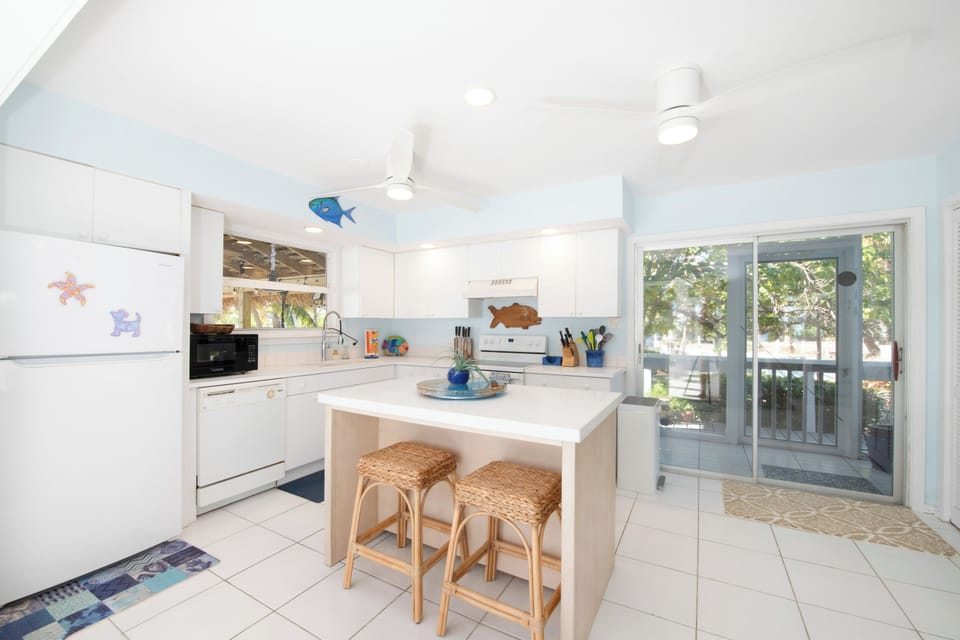 Full kitchen with modern appliances and island seating for 2. 