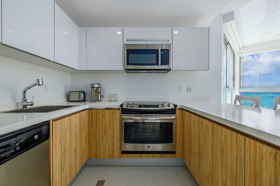 Cook with stunning ocean views in your fully equipped kitchen featuring sleek appliances and modern finishes.