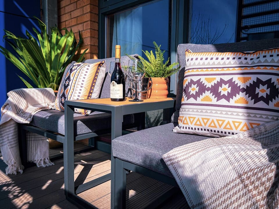 Private balcony with stylish seating, plants and space for morning coffee or evening wine.