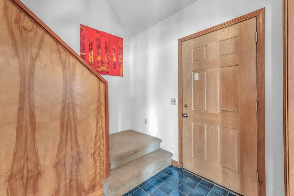 Step into your welcoming entrance with beautiful wood details and vibrant artwork greeting you home.
