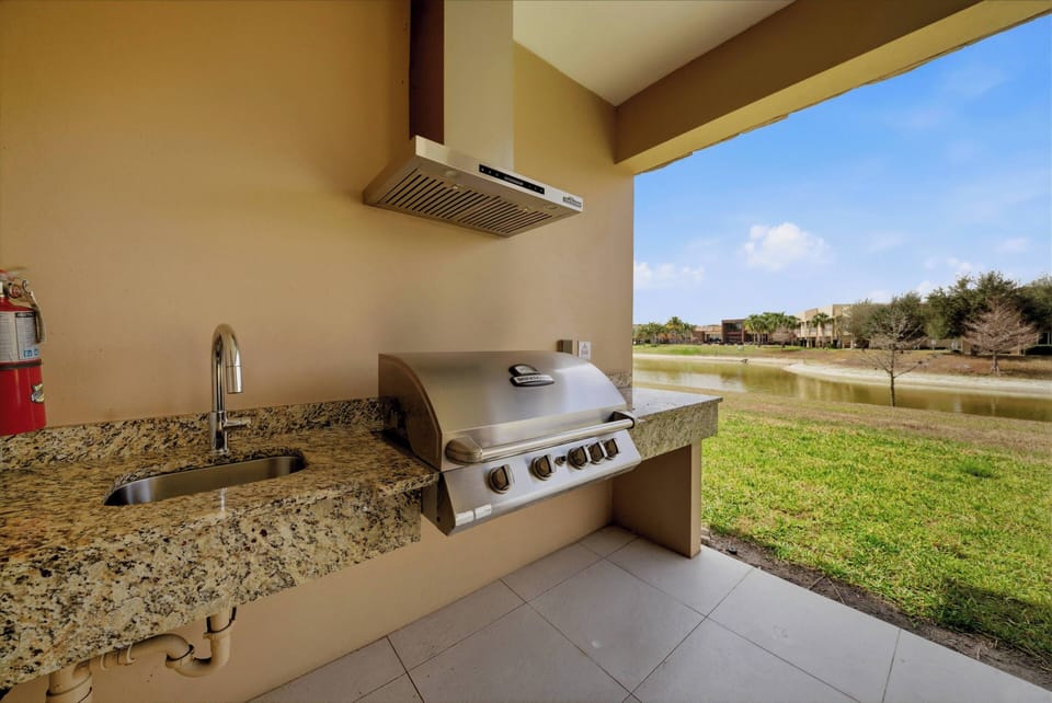 Step outside to this well-appointed outdoor grilling area, featuring a sleek stainless steel grill set against a stunning granite countertop. Enjoy the fresh air and expansive views, perfect for alfresco dining under the open sky.