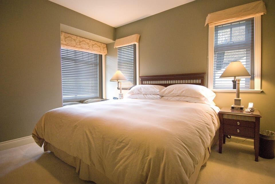 Junior Suite king bed with 3 garden view windows