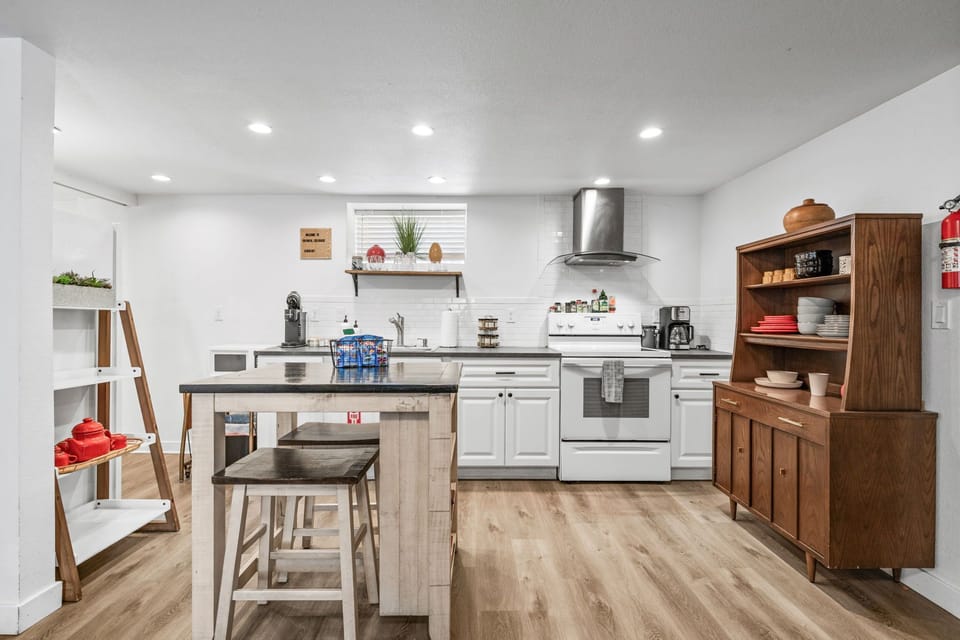 Your fully equipped kitchen awaits with modern appliances, spacious island seating, and warm wood accents for memorable meal preparation.
