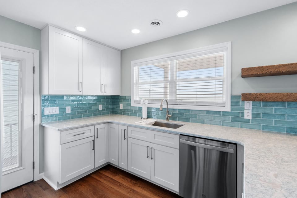 Bright, modern kitchen with sleek countertops and vibrant backsplash