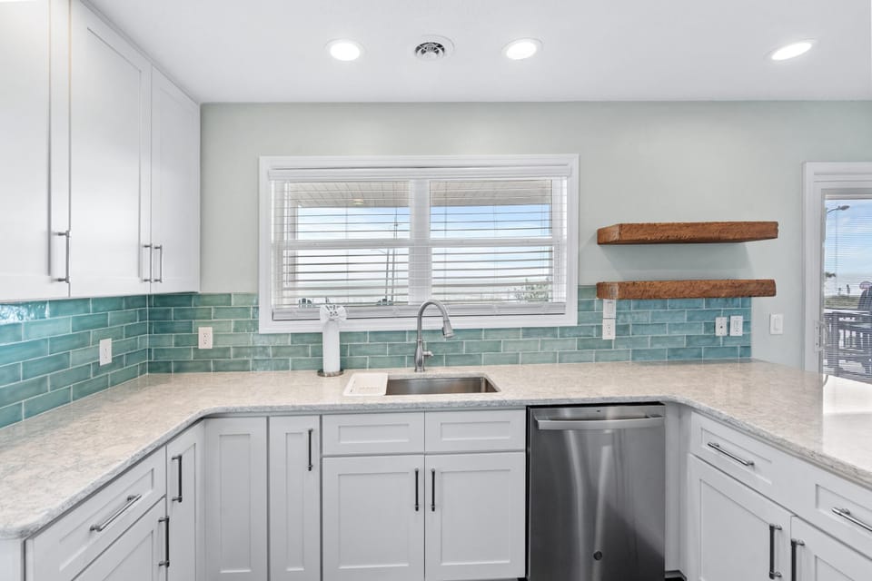 Bright, modern kitchen with sleek countertops and ocean views