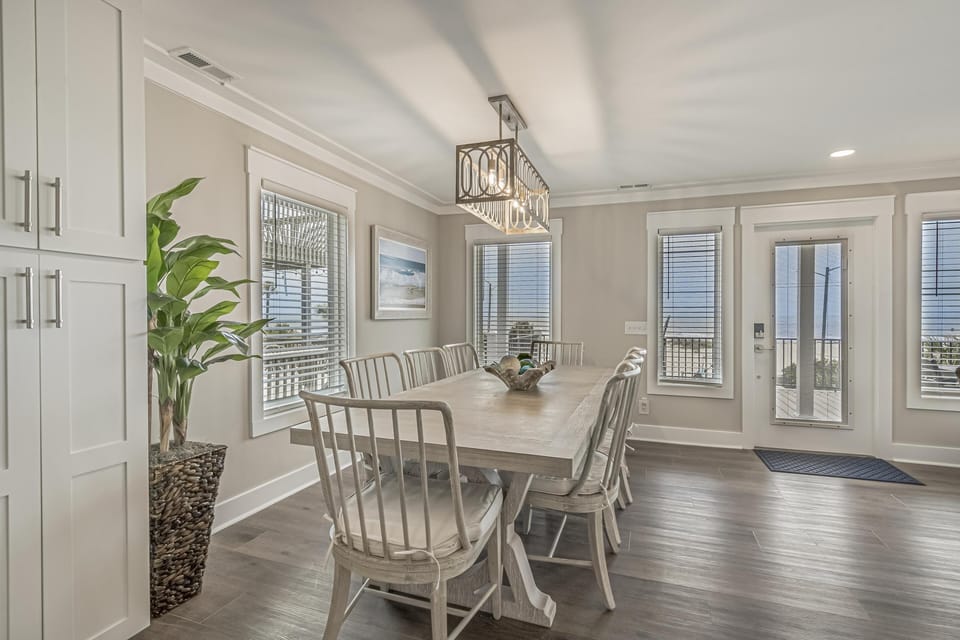 Bright dining room with waterfront views and cozy seating