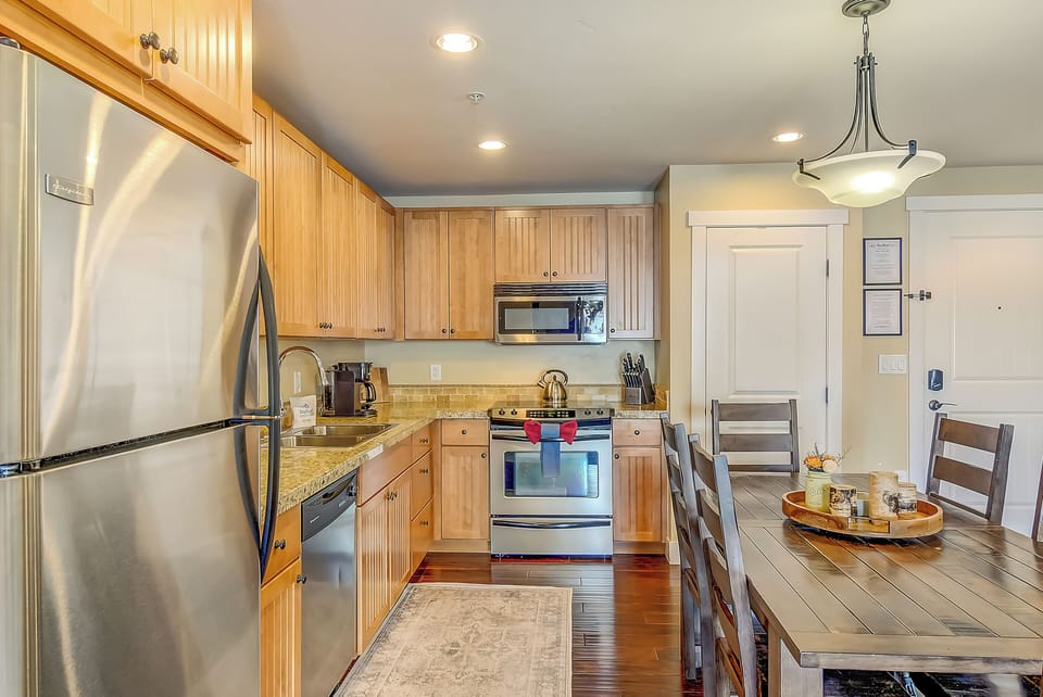 Your fully-equipped kitchen invites culinary adventures with granite counters, stainless appliances, and a cozy dining table perfect for morning coffee.