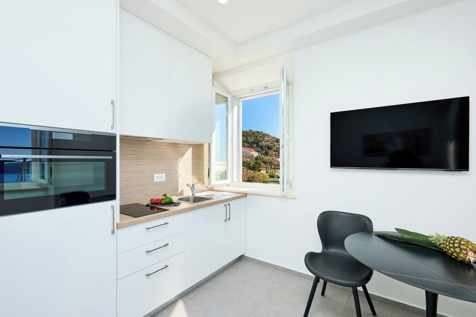 Enjoy views of the green hillsides from this modern kitchenette, one of two private units on the villa's first floor.