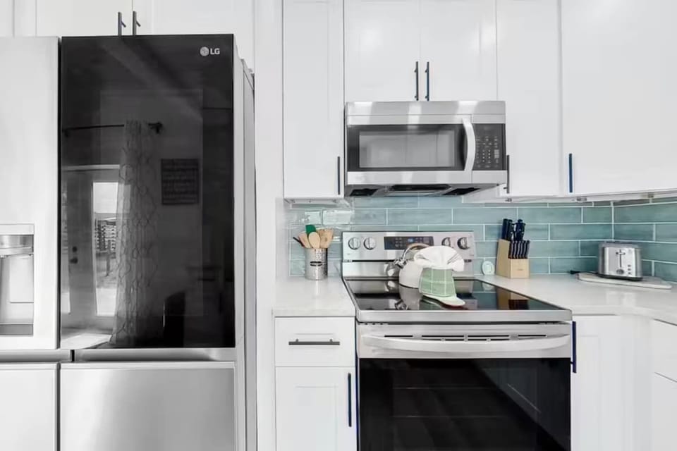 Fully stocked kitchen with modern appliances and everything you need to cook at home.