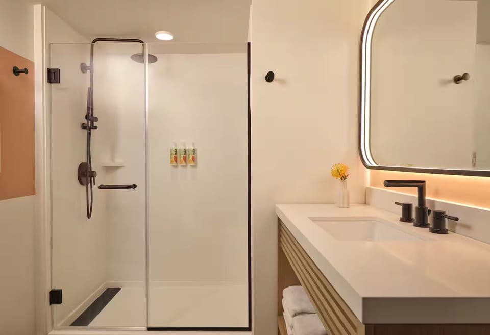 Rinse off under the rainfall shower in a spotless space.
