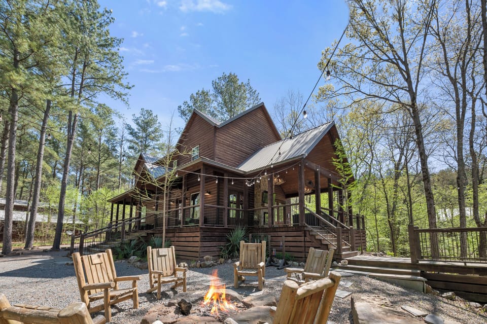 Outdoor fire pit with Adirondack chairs for cozy evenings under the sun.