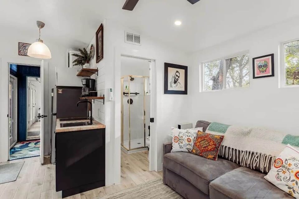 This private suite offers a comfortable retreat with a fully equipped kitchenette, ensuite bathroom, washer/dryer, and a plush sofa that converts into a queen bed. A convenient rollaway bed is also available in the closet for extra guests.