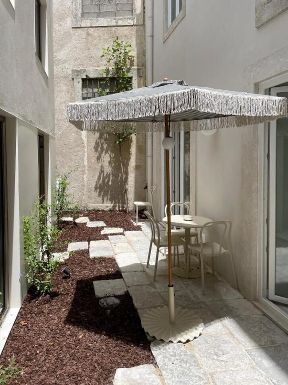 Unwind in a quiet courtyard with sunny café table.