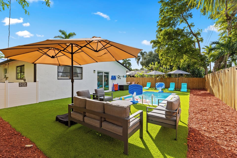 Shaded lounge seating overlooking the private pool—your sunny backyard hangout spot.