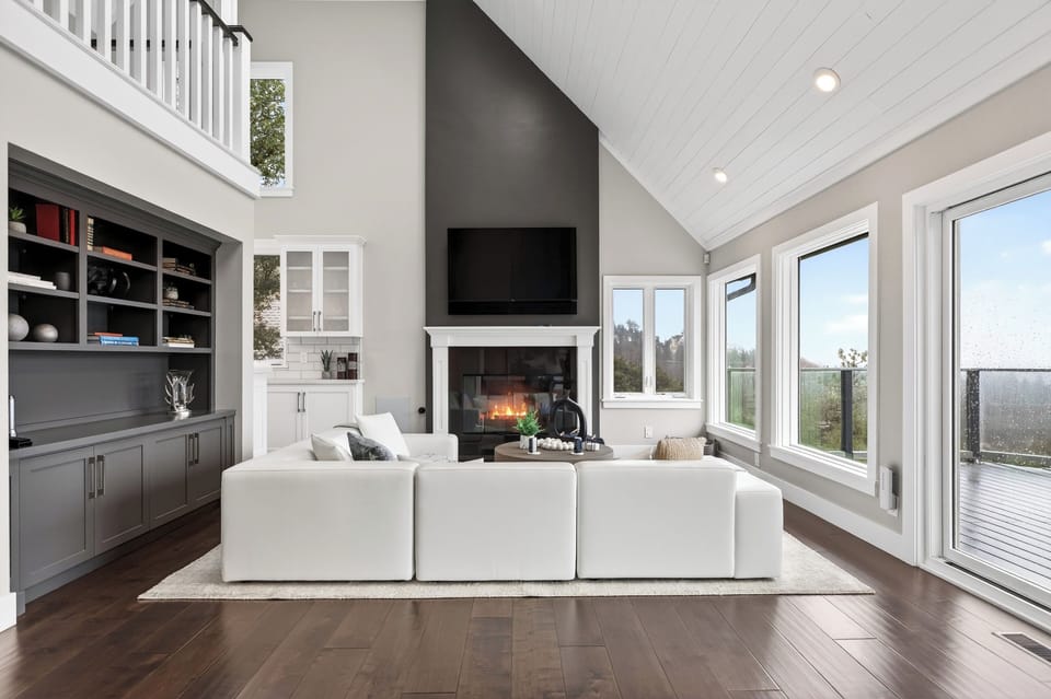 Spacious living room with high ceilings and a modern minimalist fireplace.