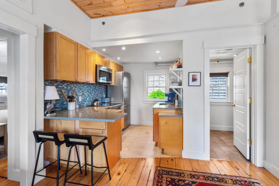 Fully equipped kitchen and door to bathroom