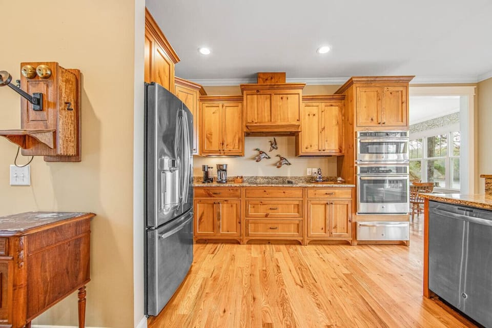 Bright and fully equipped kitchen with modern appliances and bar seating.