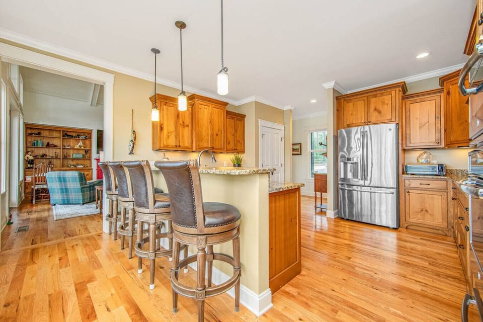 Spacious kitchen featuring modern appliances and convenient bar seating.
