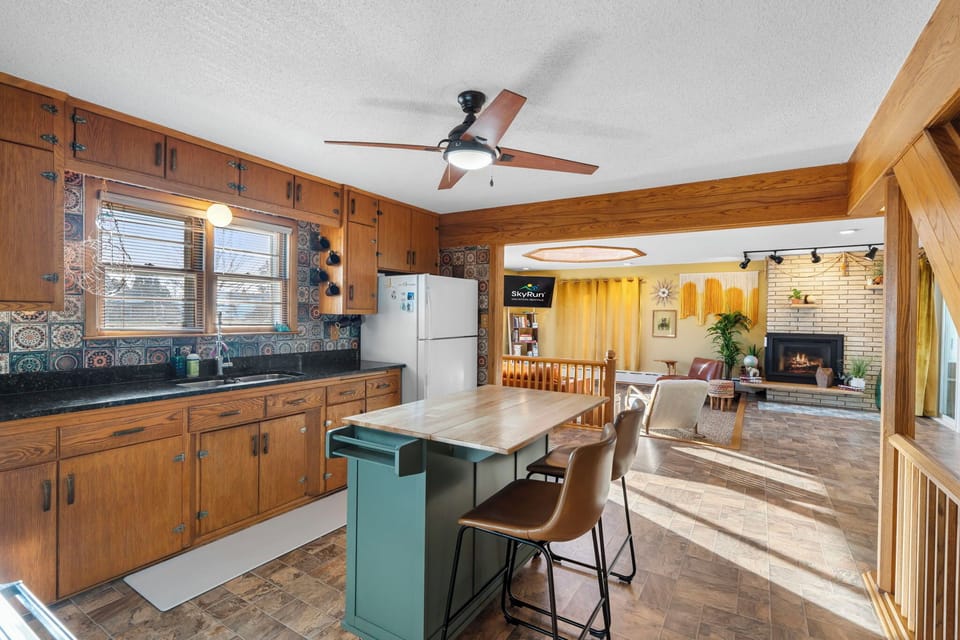 Gather around your spacious kitchen island for morning coffee while natural light streams through windows, connecting seamlessly to your cozy living area.