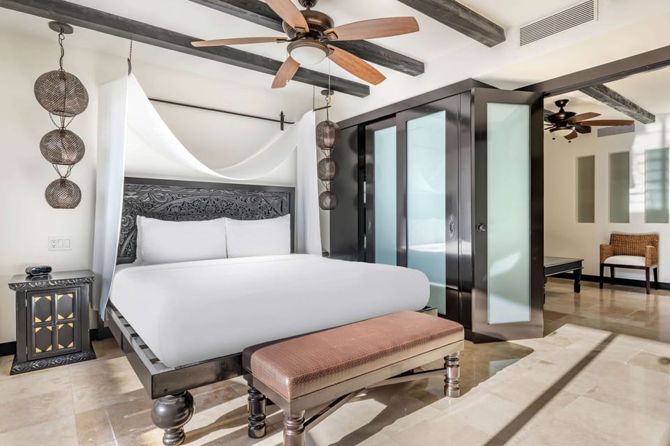 Unwind in a serene canopy bed after beach days.