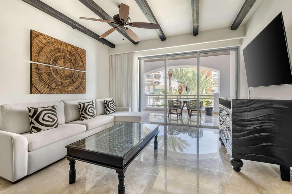 Unwind on the plush sofa with sunshine and balcony views.