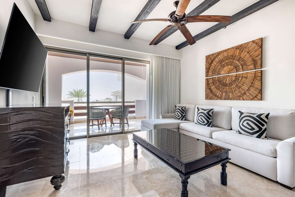 Lounge with a movie night setup and airy resort ambiance.