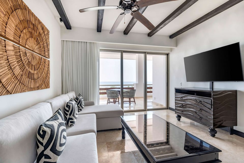 Relax after the beach with big-screen TV and balcony air.