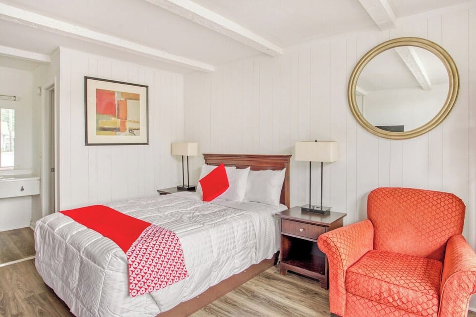 Unwind in a bright bedroom with crisp linens and sunlight.
