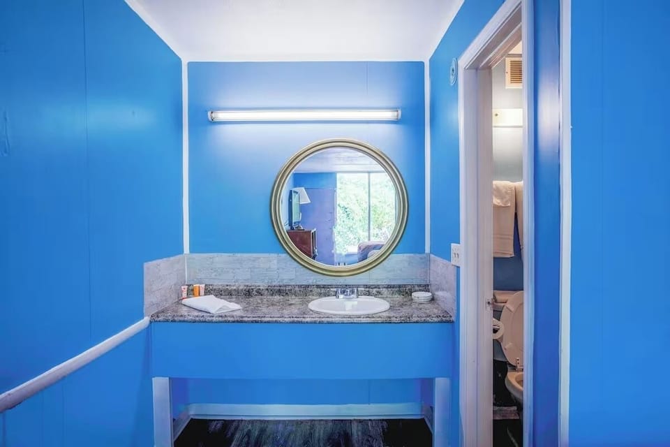 Freshen up at the bright vanity with generous counter space.