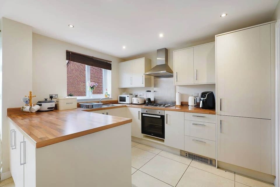 Kitchen equipped with all essentials, including a washer & dryer, oven, fridge and full cookware set.