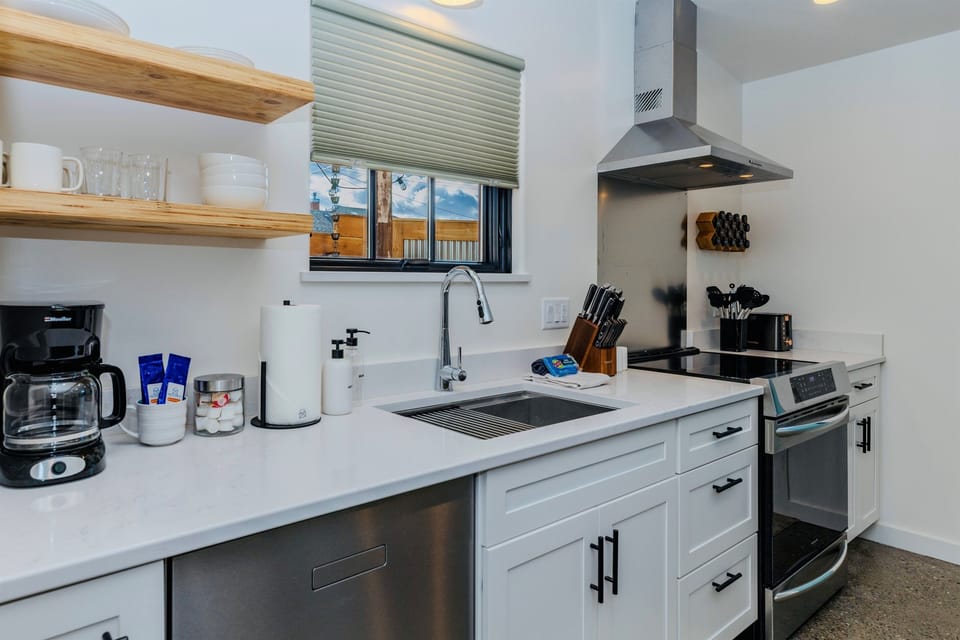 This small kitchen has everything you need, from coffee to dishes & cookware to dishwasher & induction stove