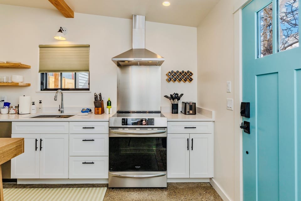 A full kitchen, including induction stove, is ready for a quick meal, or a 5-course dinner.