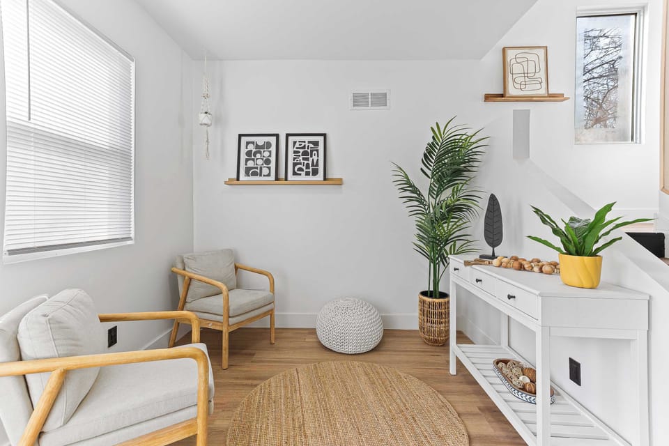 Charming living space with natural light, warm wood floors, and modern décor accents. A comfortable area perfect for relaxing, reading, or enjoying quiet moments during your stay.