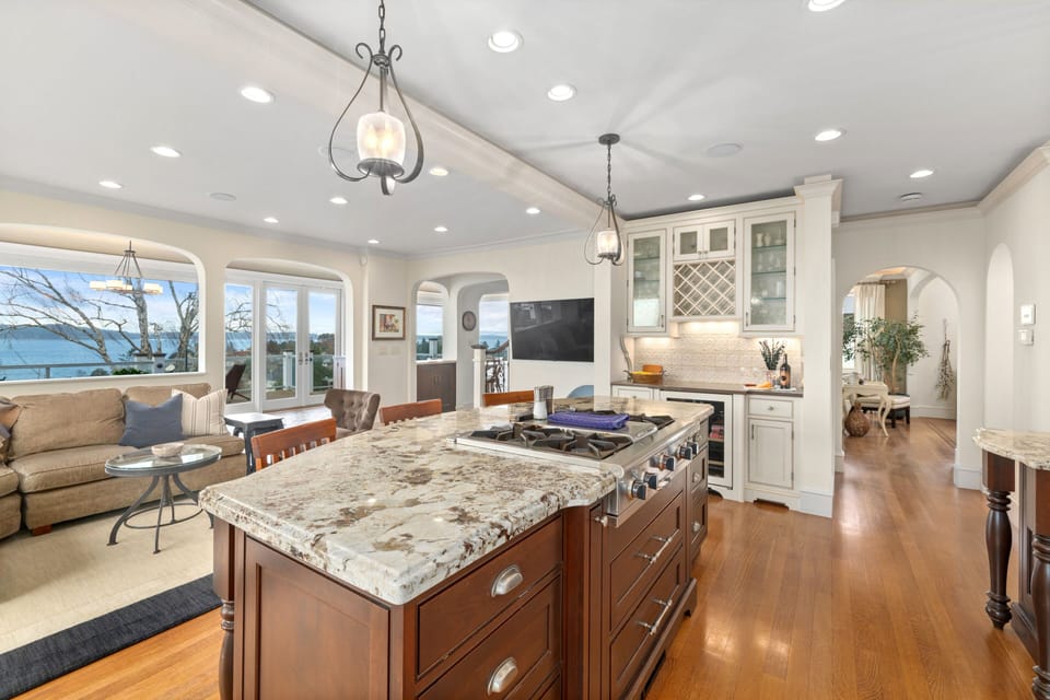 Bright, open kitchen with island, generous counters & seamless flow to rooms.