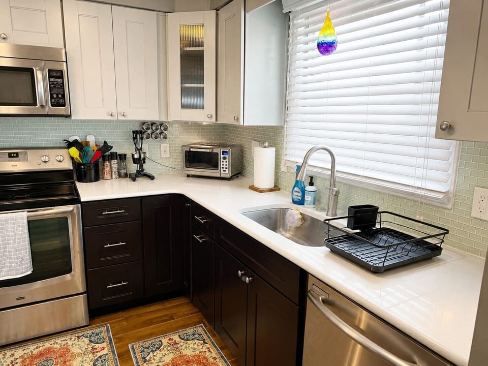 Fully equipped kitchen with dishwasher, toaster, microwave and cookware.