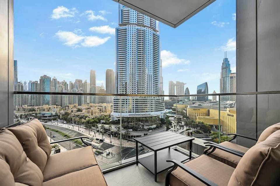 Private balcony with seating and a glimpse of the Burj Khalifa and Dubai Fountain