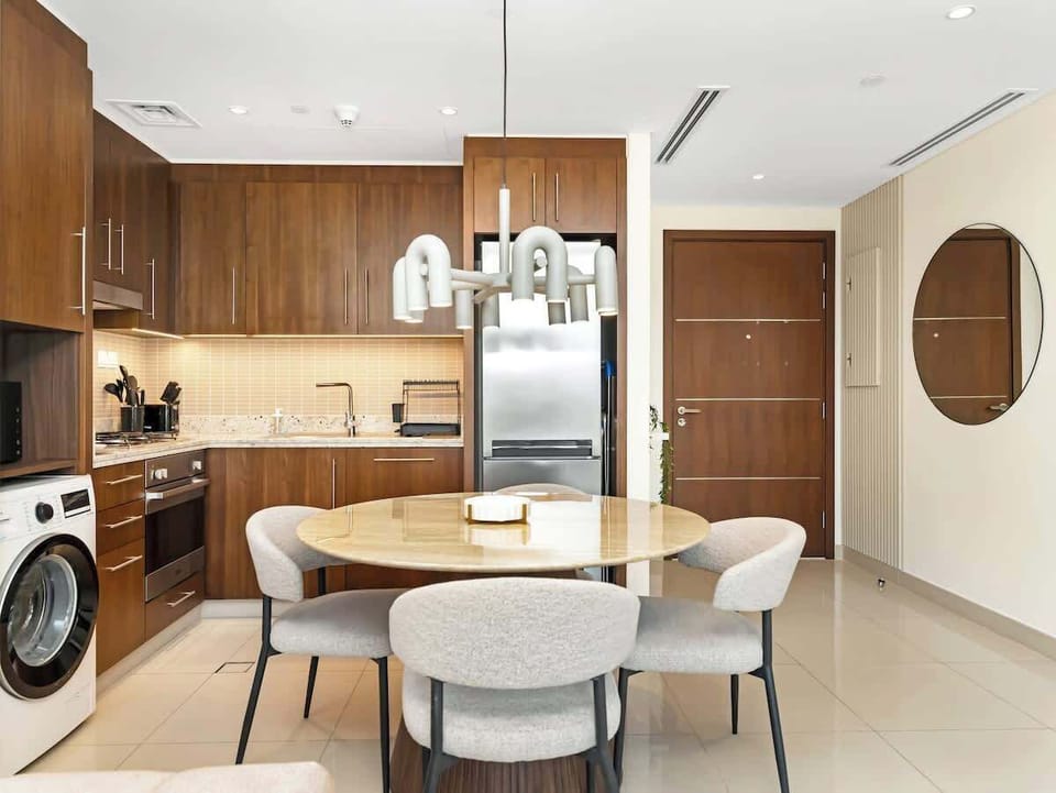 Fully equipped kitchen with modern appliances, in-suite washer/dryer, and a cozy dining area — perfect for home-cooked meals and longer stays.
