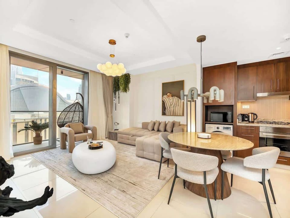Dine in this open-concept space featuring a cozy round table with natural light and Burj Khalifa views!