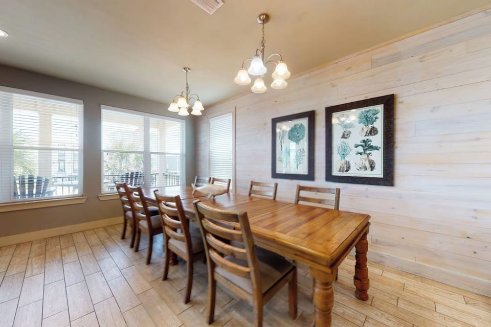 Dining area with a table and chairs set for 8 and additional seating for 4 at the breakfast bar 