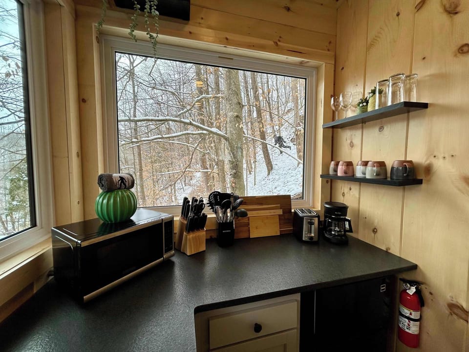 Sunlit countertops and large windows make this kitchen a peaceful place to start your morning.  It includes a mini fridge, microwave, portable induction cooktops, toaster, and a standard drip coffee maker. Please provide your own coffee. 