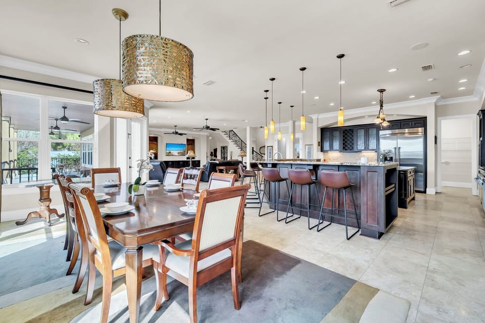 From dinner at the table to conversation at the island, this space glows under elegant pendant lighting.